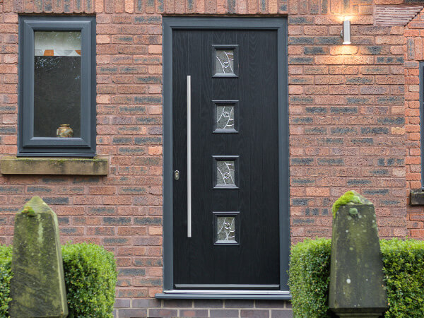 A black composite door with a long silver handle